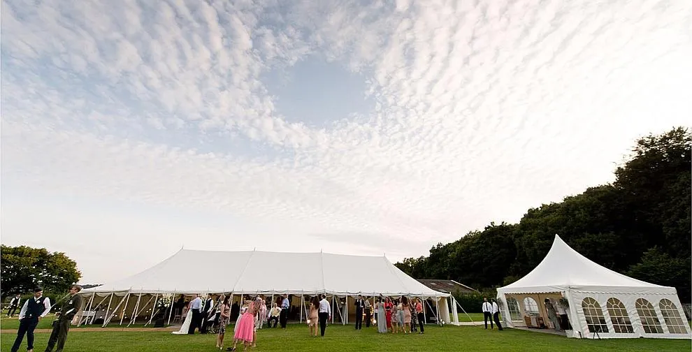 A traditional pole marquee with a pagoda entrance, seen from outside
