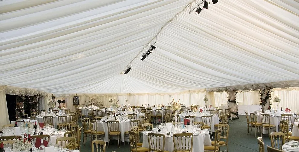 Two linked framed marquees seen from the garden