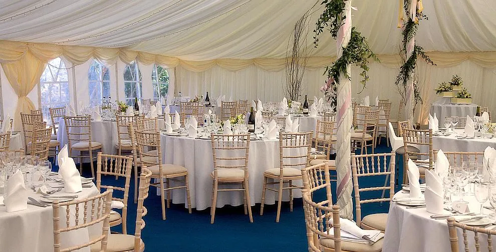 Tables dressed with linen and place settings