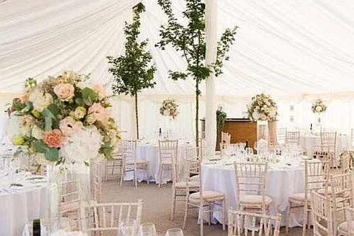 A round wooden bar unit inside a marquee