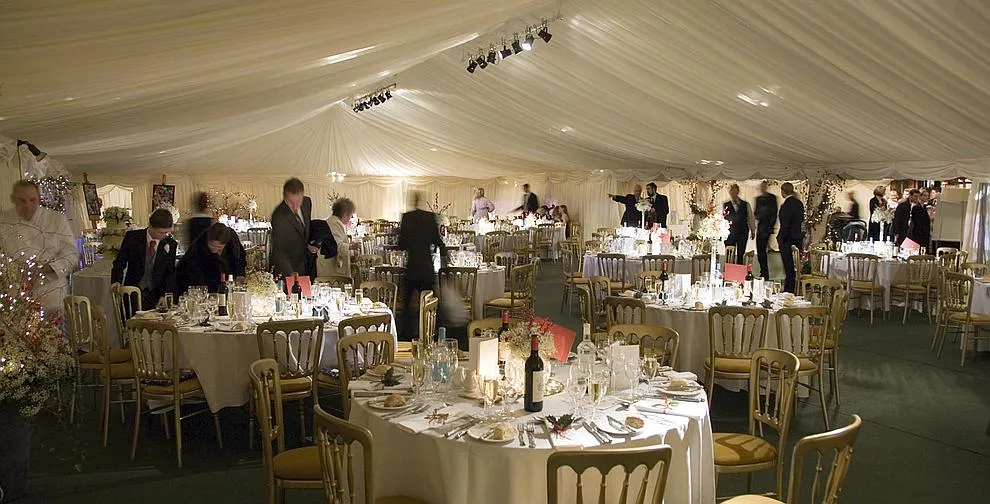A framed marquee erected beside a house as an extension to the building